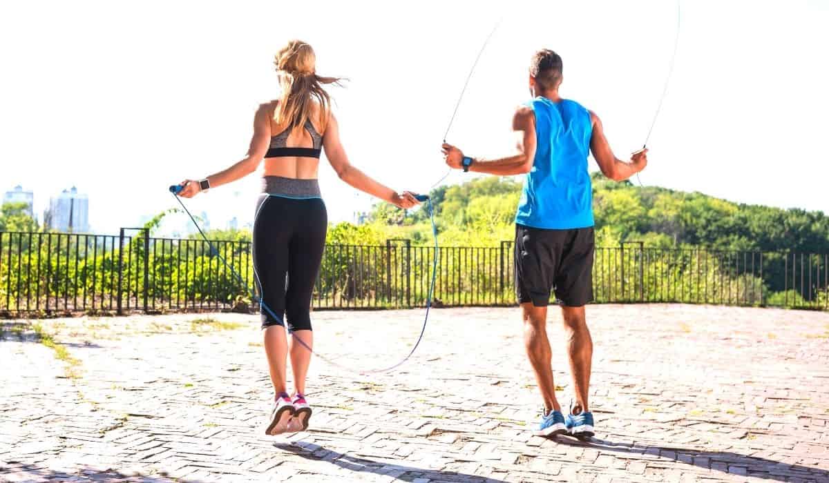 man and woman jump rope outside with their backs to us wearing the best shoes for jumping rope